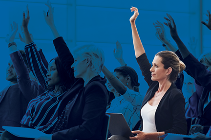 Safety professional woman raising her hand in a classroom of other safety professionals