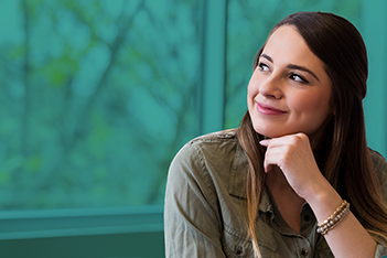 Young safety professional woman sitting in a classroom and looking out the window because she cannot focus