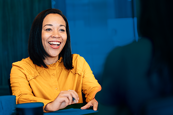 Young woman safety professional with a yellow blouse working to negotiate her salary during a job interview
